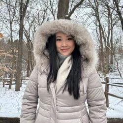 A person wearing a parka in a snowy outdoor setting